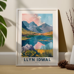May include: A framed print of a mountain lake scene with a pink and blue sky. The text "LLYN IDWAL WALES" is at the bottom of the print.