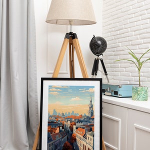 May include: A black framed print of a cityscape with a church steeple in the background. The print has the text "BRUSSELS BELGIUM" at the bottom.