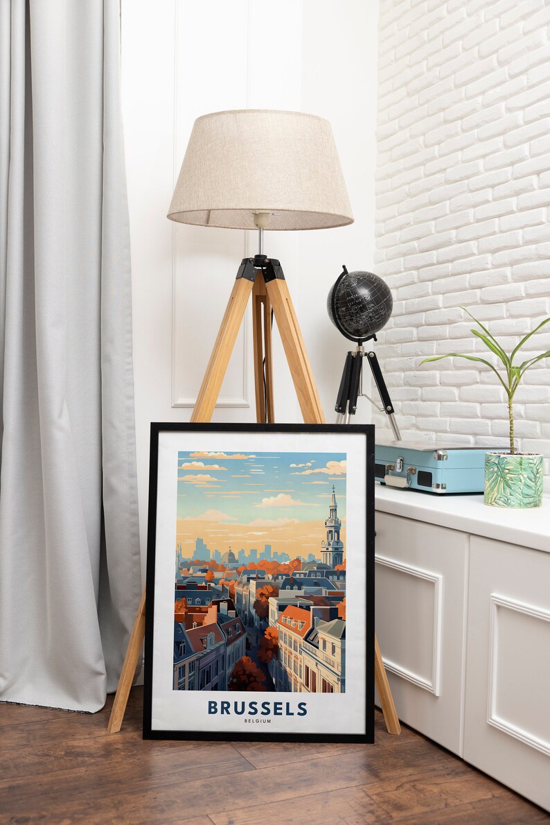 May include: A black framed print of a cityscape with a church steeple in the background. The print has the text "BRUSSELS BELGIUM" at the bottom.