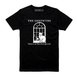 May include: Black t-shirt with a white graphic of a cat in a window. The text "THE SMEOWTHS" is above the window, and "There's a cat that never goes out" is below. The shirt has the "GOTHICAT" logo at the top.