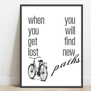 May include: Black and white print with a quote that reads "When you get lost you will find new paths". A black and white illustration of a bicycle is below the quote.