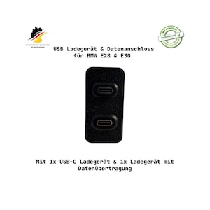 Könnte beinhalten: Schwarzes USB-Ladegerät mit zwei USB-C-Anschlüssen, entworfen für BMW E28 und E30 Modelle. Der Text auf dem Bild lautet "USB-Ladegerät & Datenanschluss für BMW E28 & E30" und "Mit 1x USB-C-Ladegerät & 1x Ladegerät mit Datenübertragung."