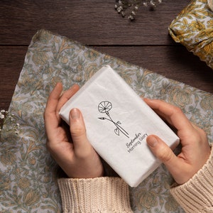 May include: A white gift box with a black and white illustration of a flower and the text "September Morning Glory".