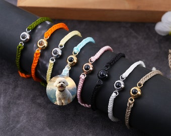 May include: A set of ten colorful braided bracelets with a small round charm featuring a black eye. Each bracelet has a different color, including green, orange, yellow, light blue, pink, black, white, and beige. The charms are made of metal and have a shiny finish.
