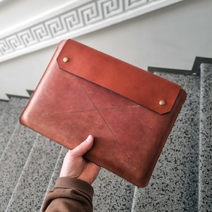 May include: A white ceramic mug with a black handle and the text "But First, Coffee" in a black, bold font. The mug is on a white surface. The mug is approximately 4 inches tall.