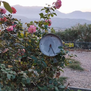 Handmade wine themed wall clock with natural materials found on the island of Crete.