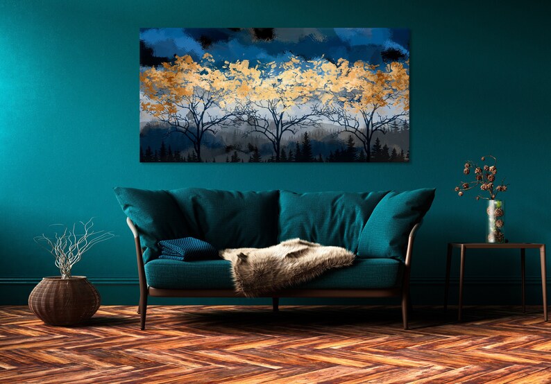 a living room with a blue couch and a painting on the wall