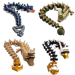 May include: Four dragon figurines, each representing a branch of the U.S. military. The Air Force dragon is blue, the Army dragon is green, the Navy dragon is tan, and the Marine Corps dragon is navy blue.