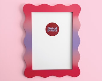 May include: A rectangular picture frame with a wavy edge, featuring a gradient of colors from red to purple. The frame has a white interior and a circular sticker with the text "tinted prints".