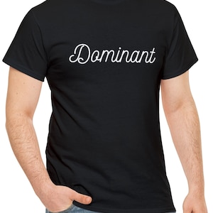 May include: A black t-shirt with the word "Dominant" written in white cursive script.