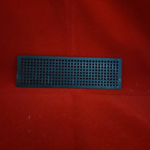 May include: A black plastic vent cover with a square grid pattern.