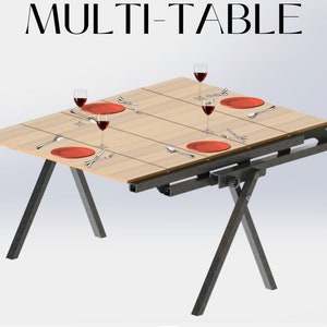 Op de afbeelding: Een multi-tafel met een houten blad en zwarte metalen poten. De tafel is gedekt met vier couverts, elk met een rood bord, een vork, een mes en een lepel. Er staan vier glazen rode wijn op tafel.