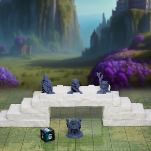 May include: Five miniature figurines of fantasy creatures, painted in a light gray color, are arranged on a white stone bridge. The bridge is made of several rectangular blocks and is set on a blue and white checkered surface. A blue and green dice with the number 3 is visible in the foreground.