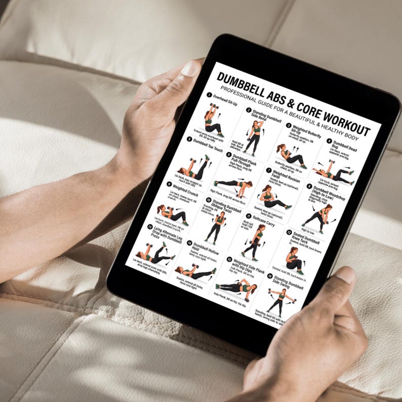 May include: A black tablet shows a "Dumbbell Abs & Core Workout" guide with exercise illustrations. The tablet is held by a person, and the screen displays various exercises for a beautiful and healthy body. The background is a neutral colour.