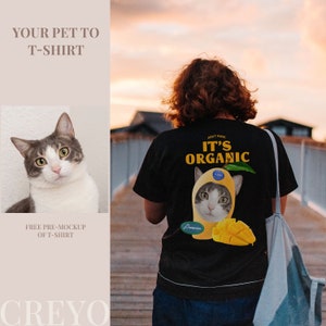 May include: A black t-shirt with a graphic of a cat wearing a mango costume. The text "Don't Panic It's Organic" is printed on the shirt.