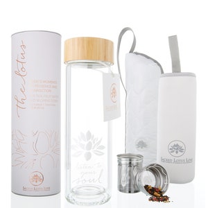 May include: A glass water bottle with a bamboo lid and a white silicone sleeve. The bottle has a lotus flower design and the text "listen to your soul". It comes with a stainless steel tea infuser and a small bag of loose leaf tea.