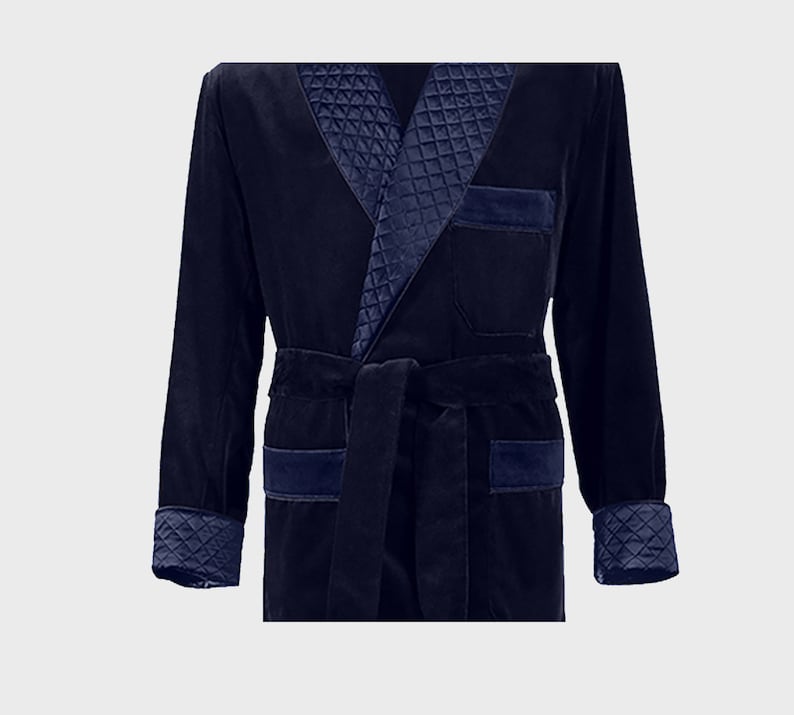 May include: A navy blue velvet robe with a quilted satin collar and cuffs. The robe has a self-tie belt and two patch pockets.