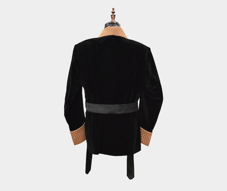 May include: A black velvet robe with a brown velvet collar and cuffs. The robe has a black satin sash.