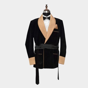 May include: A black velvet robe with a tan quilted collar and cuffs. The robe has a sash tie and a shawl collar.