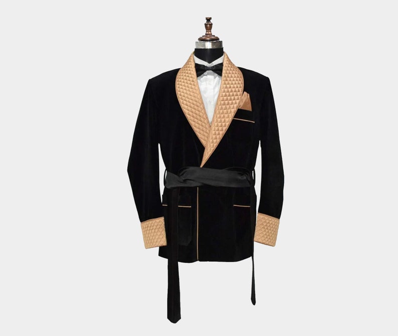 May include: A black velvet robe with a tan quilted collar and cuffs. The robe has a sash tie and a shawl collar.
