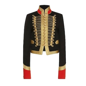 May include: A black cropped jacket with gold braid trim and buttons. The jacket has a red lining on the cuffs.