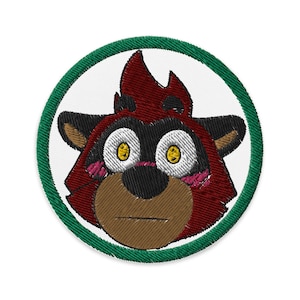 May include: Embroidered patch featuring a red and black cartoon animal with yellow eyes and a surprised expression. The animal is surrounded by a green circle.