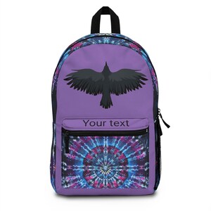 May include: Purple backpack with a black raven silhouette and a tie-dye pattern on the bottom. The text "Your text" is printed on the front.