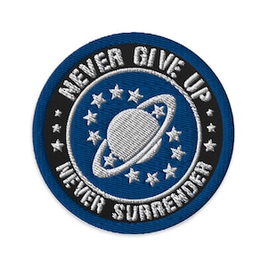 May include: A blue and black embroidered patch with a white planet and stars. The text on the patch reads "Never Give Up Never Surrender".