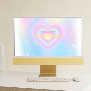 May include: A computer screen displaying a rainbow heart with the text "Always Begin With" and Arabic text. The background is a light blue with white stars.