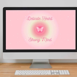 May include: A pink computer screen with a pink butterfly and the text "Delicate Heart Strong Mind" on a pink background with white stars.