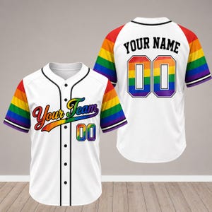 May include: White baseball jersey with rainbow-colored sleeves and accents. The front displays "Your Team" in rainbow lettering and the number "00". The back features "YOUR NAME" above the number "00", also in rainbow colors.