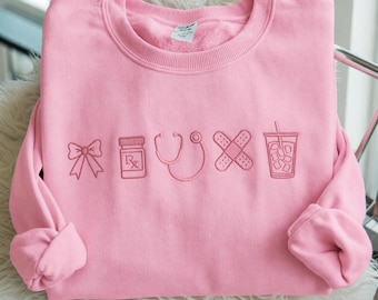 Embroidered Nurse Icon Sweatshirt, Healthcare Shirt, CNA Sweatshirt, Medical Assistant, Nursing Grad Gift, Coquette Nursing Sweatshirt