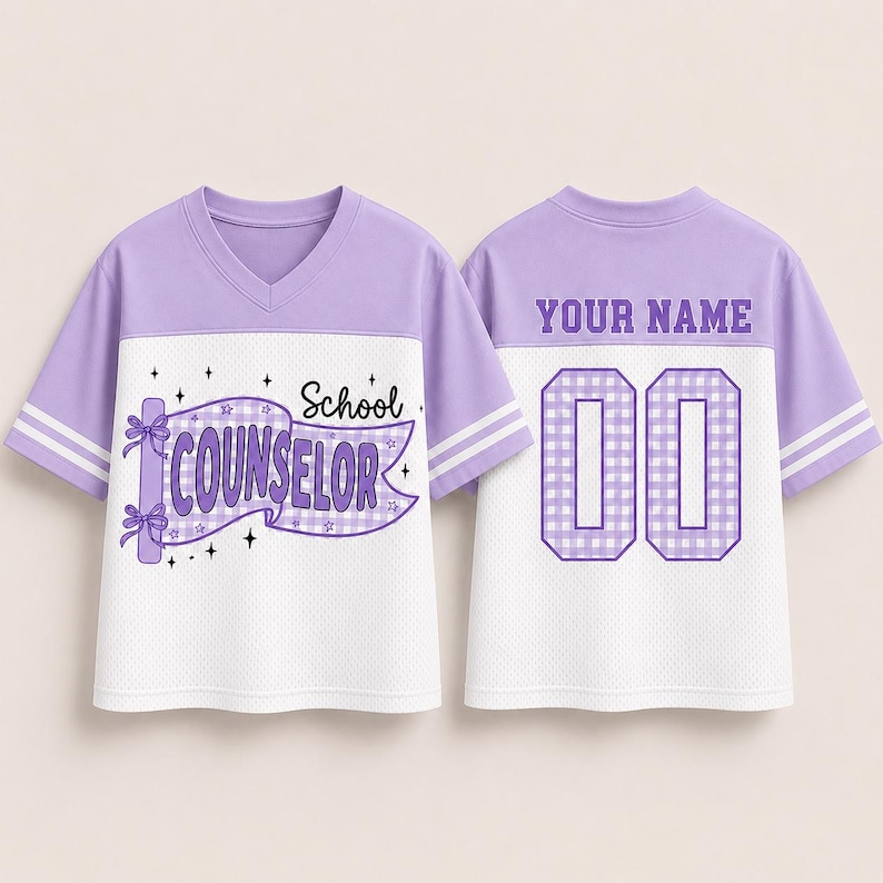 May include: A lavender and white V-neck jersey with short sleeves and double white stripes. The front features a purple gingham banner with the text School COUNSELOR and stars. The back displays the text YOUR NAME above the number 00.
