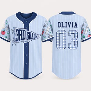 May include: A light blue pinstriped baseball jersey with dark blue trim. The front features a pennant graphic with the text 3RD GRADE. The back displays the name OLIVIA and the number 03 in a blue and white gingham pattern. School supply icons decorate the sleeves.