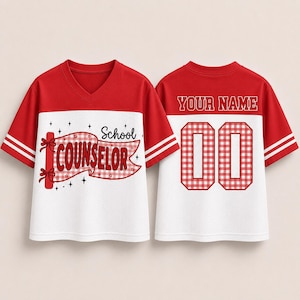 May include: A red and white V-neck jersey with short sleeves and two white stripes on each sleeve. The front features a red gingham banner with the text School COUNSELOR. The back displays the text YOUR NAME above the large red gingham numbers 00.