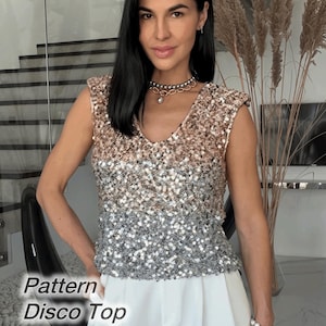 May include: A sleeveless top featuring a V-neckline and an ombre sequin pattern that transitions from a warm bronze at the shoulders to a cool silver at the hem. The garment is labeled with the text Pattern Disco Top on the lower left side.
