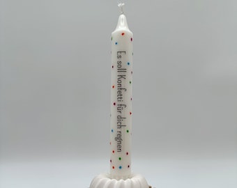 May include: White birthday candle with colourful sprinkles and the text "Es soll Konfetti für dich regnen" on the side. The candle is sitting on a white cake mould.