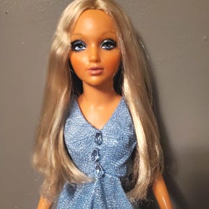 May include: A set of three ceramic mugs with a speckled, matte finish. The mugs are in shades of cream, light gray, and dark gray. Each mug has a simple, minimalist design and a rounded handle.