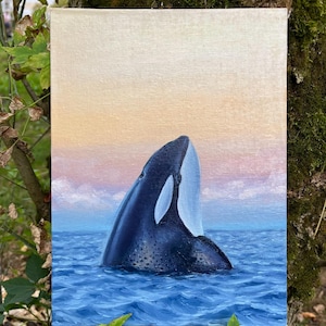 Painting Orca emerges from the sea water