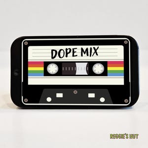 May include: Black cassette tape design with the words "DOPE MIX" in white. The tape features a rainbow stripe and a retro aesthetic. The design is on a black background.