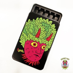 May include: Black metal case with a hinged lid, featuring a cartoon devil face with lettuce hair and the text "Devil's Lettuce." The case is open, revealing a black interior with compartments. The logo "Reggie's Hut" is visible.