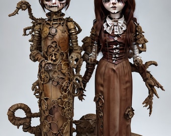 May include: Two steampunk-inspired dolls with pale skin, dark eye makeup, and eerie expressions. One doll is adorned with gears and mechanical elements, while the other wears a brown dress with a white collar. Both dolls have dark hair and are holding hands.