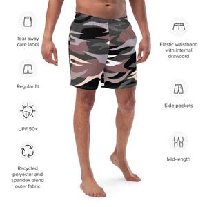 May include: Mid-length shorts featuring a camouflage pattern in shades of black, gray, and light pink. The shorts include an elastic waistband with an internal drawcord, side pockets, a regular fit, UPF 50+ protection, and a tear away care label.