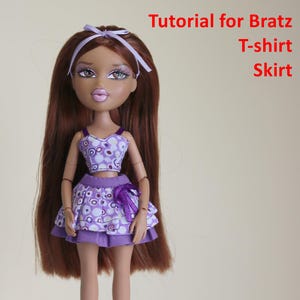 May include: A doll with long brown hair and a light purple headband, wearing a purple and white patterned crop top and a matching tiered skirt with a bow. The doll wears white and dark brown platform shoes. Text reads: Tutorial for Bratz T-shirt Skirt PDF.