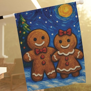 May include: A decorative outdoor flag featuring a whimsical painting of two gingerbread people. The artwork depicts a night scene with a full moon, a Christmas tree, and falling snow. The gingerbread couple is smiling and wearing bow ties and bows.