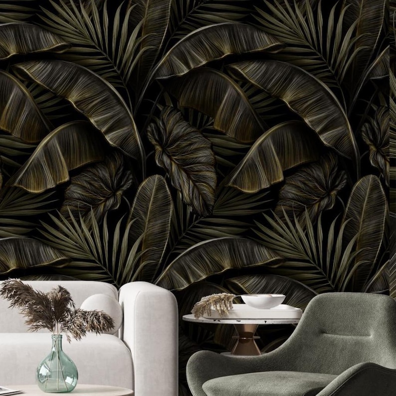May include: Dark, detailed wallpaper featuring a repeating pattern of large, stylized tropical leaves in shades of olive green and gold against a black background. The leaves have intricate vein details, creating a lush, textured appearance. The wallpaper adds a touch of nature to any room.