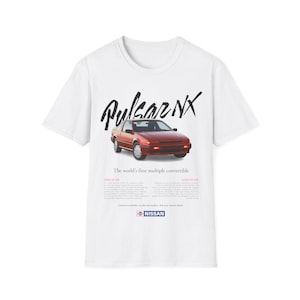May include: White t-shirt with a red Nissan Pulsar NX convertible car graphic and the text "Pulsar NX" in black. The text "The world's first multiple convertible" is below the car graphic. The Nissan logo is at the bottom of the shirt.