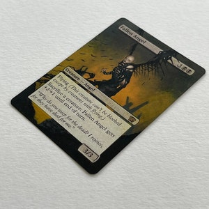 May include: A Magic: The Gathering card featuring a Fallen Angel. The card has a black border with the text "Fallen Angel" at the top. The artwork depicts a dark angel figure with outstretched wings against a sepia-toned background. The card's text describes its abilities.