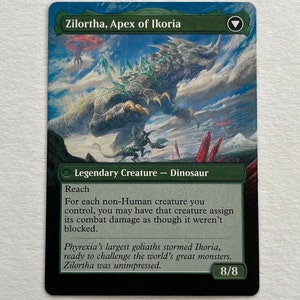 May include: A green and black Magic: The Gathering card featuring a large, green dinosaur creature with a blue background. The card is titled "Zilortha, Apex of Ikoria" and has the text "Legendary Creature - Dinosaur" and "Reach". The card has a power and toughness of 8/8.