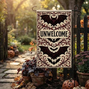 Könnte beinhalten: Eine rechteckige Gartenflagge mit cremefarbenem Hintergrund und dunkelroten sowie schwarzen, verzierten Schnörkelmustern. Das Design zeigt drei stilisierte Fledermausillustrationen und das Wort UNWELCOME in fetten schwarzen Großbuchstaben.